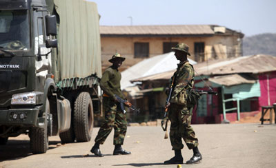 Nigerian Army troops mill around one of their new SINOTRUCK lorries