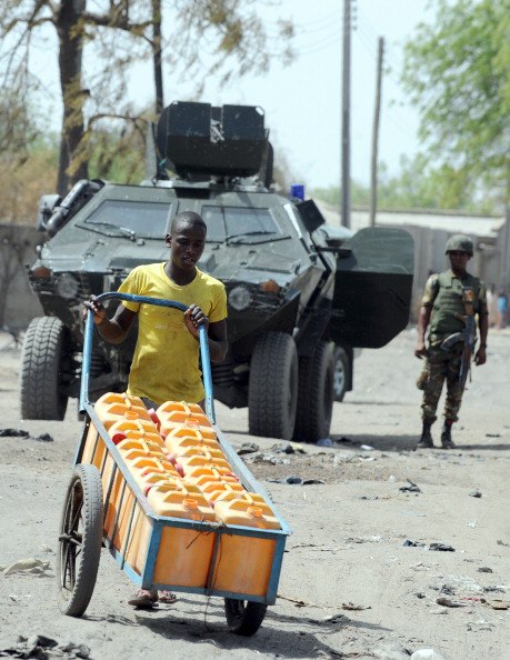 A soldier stands beside an Otokar Cobra APC at Baga in the Far Northeast corner of Nigeria